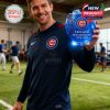 A relaxed baseball fan holds the 150th anniversary Cubs whiskey glass while enjoying the view from his seat, commemorative packaging by his side!