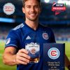 Chicago Fire FC Whiskey Glass featuring the team logo and skyline graphic, held by a man in a soccer jersey.!