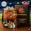 Whiskey glass marking 80 years of Cleveland Browns legacy, with golden etched cityscape, symbolic gear detail, and bold team helmet logo for dedicated fans!
