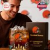 Celebrating the Cleveland Browns' history with a special edition glass, complete with golden architectural illustrations and bold team branding, held by a cheerful fan!