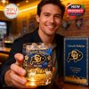 A young man proudly displays a Colorado Buffaloes commemorative whiskey glass inside a bar, highlighting the collectible nature and detailed design of the product!
