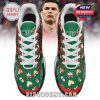 Overhead shot of CR7 sneakers featuring green tongues, Christmas icons, and playful text accents!