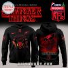 Black Eagles hoodie with red Hellfire Club graphics and Stranger Things Upside Down forest design on back.