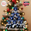 NFL-themed ornament showing Dallas Cowboys players arranged in tiers with a trophy, Christmas lights and snow effects in the background, hung by a red ribbon!