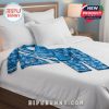 Detroit Lions pajama set placed on a bed to highlight its vibrant design, custom name feature, and full-print coverage of logos and flowers, ideal for fans who love to unwind in style!
