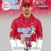Man in a red Bluey Night x Detroit Red Wings hoodie with Bluey characters, paw prints, and a matching hat.