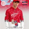 Red hoodie with Detroit Red Wings logo, Bluey cartoon characters, and playful patterns worn by a young man in a themed outfit.