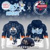 Front and back design of the Bluey x Edmonton Oilers hoodie with a matching cap, featuring cartoon artwork and NHL branding.
