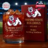 Red themed Fresno State Bulldogs whiskey glass filled with ice and amber liquid placed on a table with a branded anniversary box behind it!
