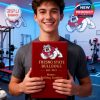 Man smiling while holding a Fresno State Bulldogs branded gift box in a gym setting with team logos on the wall!