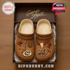 Side view of George Strait Crocs with Western-themed icons, including a skull and microphone.