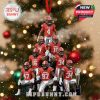 Christmas ornament showing Georgia Bulldogs players arranged in tiers with a College Football Playoff trophy, decorated with holiday lights and snow, hanging from a red ribbon on a Christmas tree!