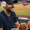 A vibrant fan clutches the Houston Astros 60th anniversary glass during a live game, embodying the team spirit and joy of baseball!