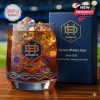 Dynamo FC whiskey glass filled with ice and featuring the team logo and space-themed details, placed next to a matching blue box.
