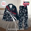 Houston Texans pajama set laid out on a bed with quilted bedding, showing off its bold design, team branding, floral details, and custom name feature—ideal for relaxed, fan-themed lounging!