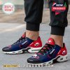 Feet wearing Texans-themed Christmas sneakers with festive red and blue design in outdoor setting!
