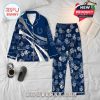 Blue Indianapolis Colts pajama set laid flat on a bed, surrounded by relaxing details like hot coffee and reading, emphasizing its personalized print, team graphics, and lounge-ready design!