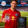 A man in a red football kit poses on a soccer field holding the Inter Miami-themed whiskey glass filled with ice. The black collector’s box is placed beside him, showcasing the logo and product branding!