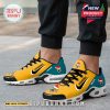 On-foot view of Jaguarsmas sneakers featuring yellow and teal colorway with holiday graphics!