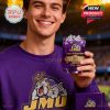 Man holding James Madison Dukes anniversary whiskey glass while smiling in a stadium setting!