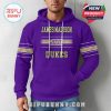 Man modeling purple hoodie from the front featuring JMU graphics and gold and white striped sleeves!