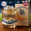 A detailed whisky glass with wave patterns and Long Beach State University branding stands beside a cream-colored box that reads “Where the Ocean Meets Opportunity”!