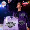 Man in Kings jacket raising LA Kings 59th anniversary whiskey glass under arena lights!