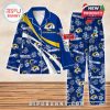 Blue and yellow Rams-themed pajamas with logo prints and tropical flowers, laid out on a wooden floor background!