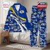 Los Angeles Rams blue pajama set with white floral graphics and logo details, hanging in a relaxed bedroom setup!