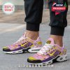 Lifestyle view of Dragon Ball sneakers on feet featuring pink and purple base, yellow Nike swoosh, and playful anime theme!