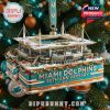 A Miami Dolphins 60th Anniversary ornament featuring a detailed replica of Hard Rock Stadium with snow and festive decorations.