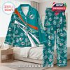 Teal Dolphins-themed pajama set with custom name area and floral prints, displayed in a neatly arranged bedroom scene!