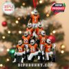 Football-themed Christmas ornament with Miami players in orange jerseys and white pants, arranged in a detailed pyramid, complete with red ribbon and college championship trophy at the base!