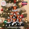 Christmas ornament showing pyramid of Miami football players in orange and white, with snow overlay and trophy base, perfect for fans wanting a festive and sporty holiday tree!