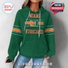 Woman modeling green hoodie from the front with Miami Hurricanes logo and orange sleeve stripes!