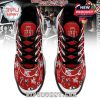 Top view of red Michael Jackson sneakers with crowned M logo and signature artwork details!