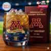 A Minnesota Golden Gophers 144th anniversary whiskey glass featuring the team's logo, waterfall engraving, and anniversary design with ice cubes inside.