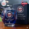 A bold blue Minnesota Twins anniversary glass with baseball inspired design and official logo positioned beside a premium gift box inside a stadium!
