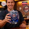 A smiling fan at a bar holding the Minnesota Twins 65th anniversary glass designed to resemble a baseball!