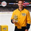 A Nashville Predators fan poses on the ice holding a gold colored whiskey glass with team branding and city artwork!
