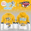 A yellow and white hoodie with Bluey cartoon characters, the Nashville Predators logo, paw prints, and fun back graphics!