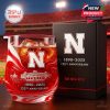 A red-and-white whiskey glass honoring Nebraska’s 135th anniversary, with a bold N logo, stadium engraving, and celebratory gift box!