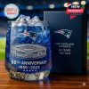 A New England Patriots 66th anniversary glass with ice cubes and a stadium engraving, celebrating 66 years of the team.