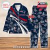 Navy blue New England Patriots pajamas with floral overlays and team branding, laid flat on a wooden surface!