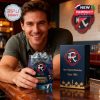 Man holding New England Revolution whiskey glass in a bar, next to branded gift box.