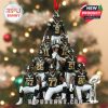 Christmas tree ornament with pyramid of New Orleans football players in black jerseys, holding hands, posed in front of a blurred Christmas tree, with a hanging loop and trophy at base!