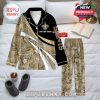 New Orleans Saints-themed pajamas with floral accents and personalization, arranged on a bed with soft lighting and home accessories!