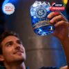 A man looks up at a whiskey glass filled with blue drink, showing the NYCFC logo and golden skyline wrapping the base!