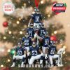 Snow-covered Christmas ornament showing New York football players in pyramid layout. Blue jerseys, red ribbon, silver trophy, and snowfall details give it a magical winter look against a tree backdrop!
