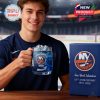 A young man in a navy Islanders shirt holding a custom whiskey glass with the NY Islanders logo and sipping ice-cold blue drink, with a branded anniversary box beside him!
